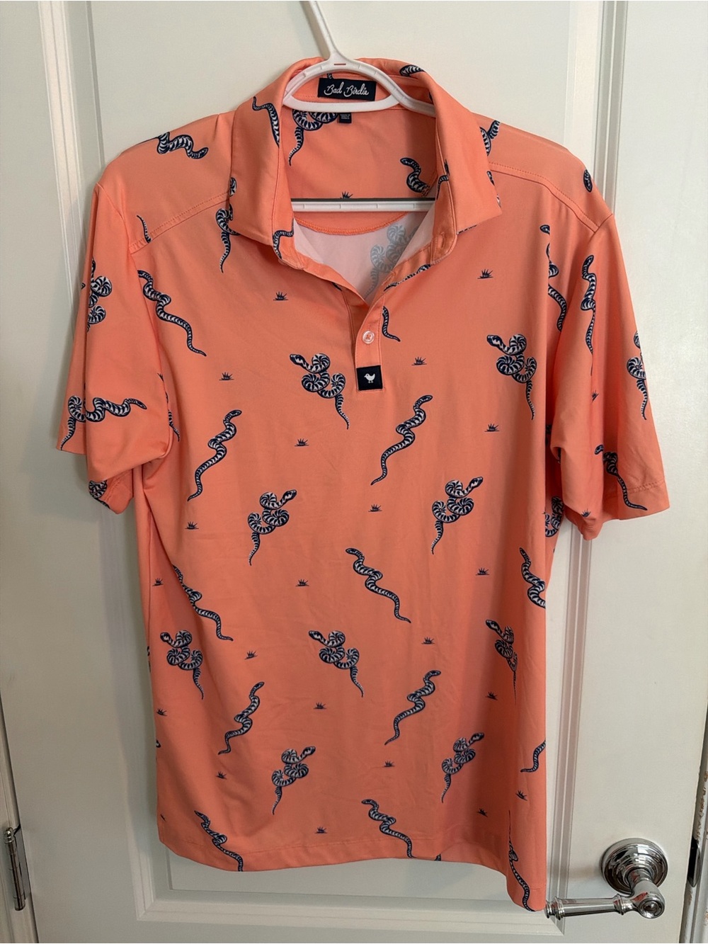 Bad Birdie Coral Polo with Navy Snake Motif